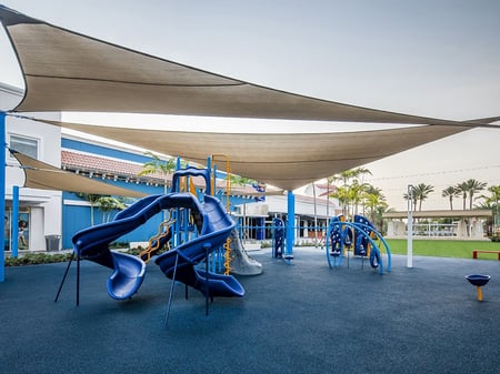 a park with blue sides under a sophisticated building cover